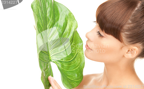 Image of woman with green leaf