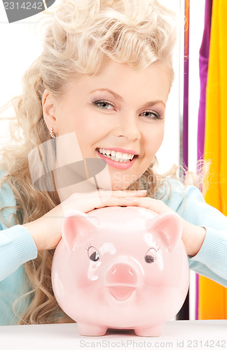 Image of lovely woman with piggy bank