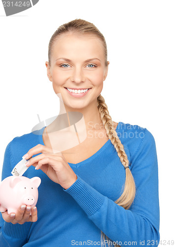 Image of lovely woman with piggy bank and money