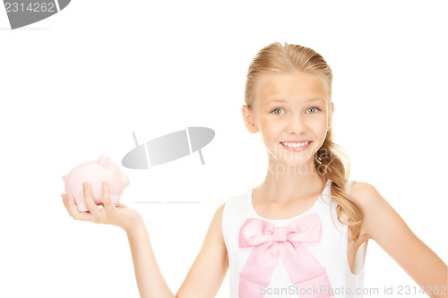 Image of lovely teenage girl with piggy bank