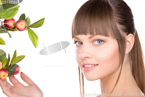 Image of lovely woman with apple twig