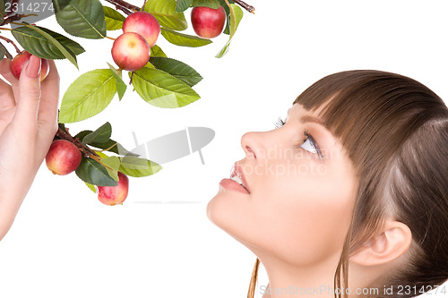 Image of lovely woman with apple twig