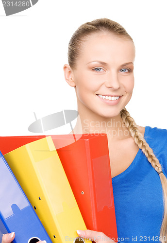 Image of young attractive businesswoman with folders