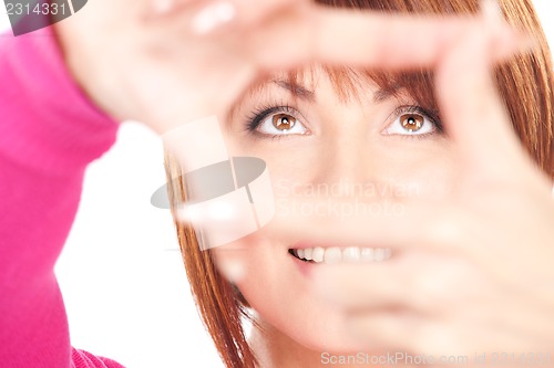 Image of lovely woman creating a frame with fingers