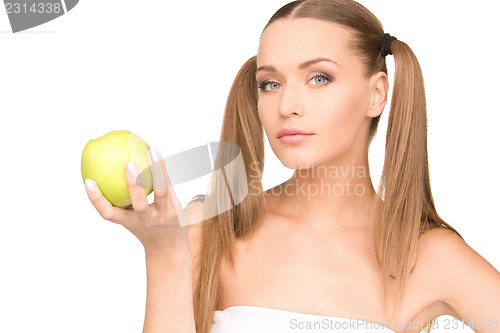 Image of young beautiful woman with green apple
