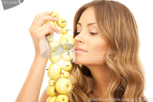 Image of lovely woman with green apples