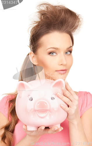 Image of lovely woman with piggy bank