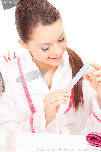 Image of woman polishing her nails