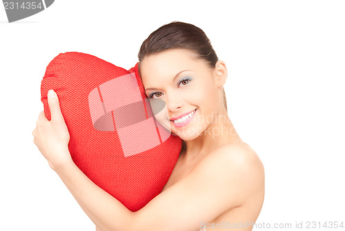 Image of woman with red heart-shaped pillow over white 