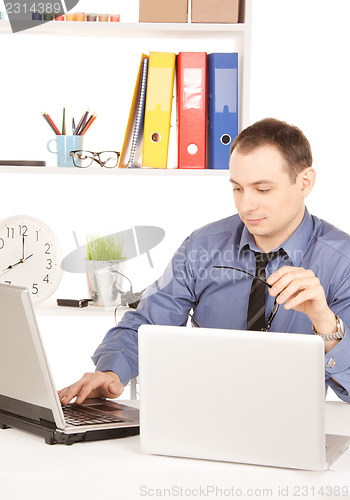 Image of businessman with laptop computer in office