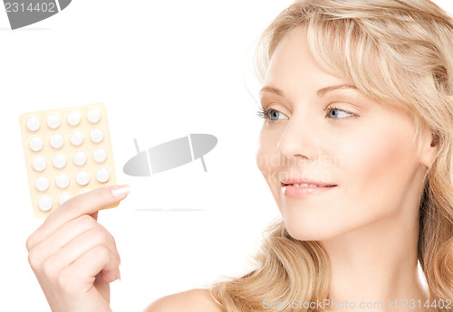 Image of young woman with pills