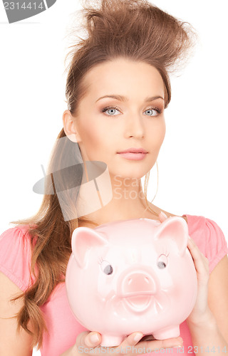 Image of lovely woman with piggy bank