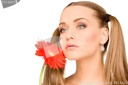 Image of woman in towel with red flower