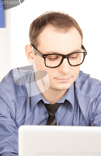 Image of businessman with laptop computer in office