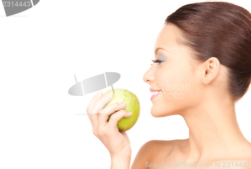 Image of young beautiful woman with green apple