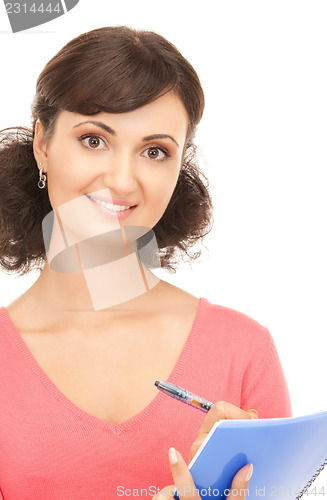 Image of young attractive businesswoman with notebook