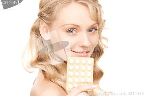 Image of young woman with pills