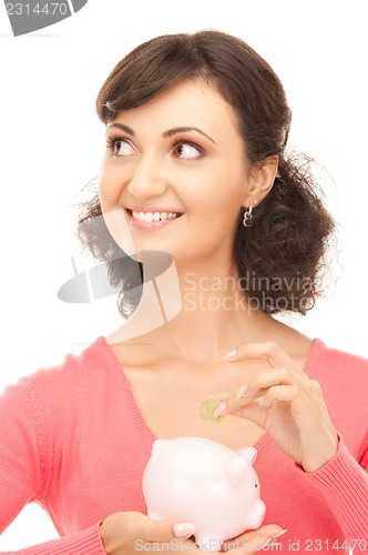 Image of lovely woman with piggy bank and money