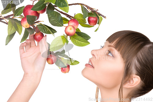 Image of lovely woman with apple twig
