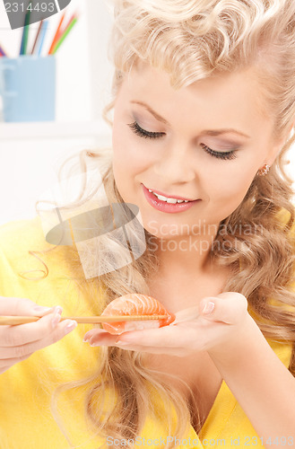Image of lovely woman eating sushi