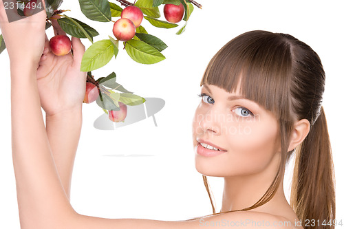 Image of lovely woman with apple twig