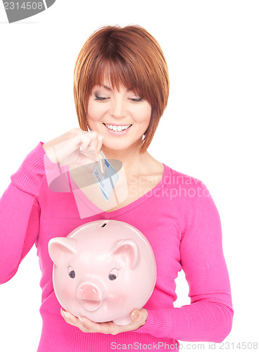 Image of lovely woman with piggy bank and money