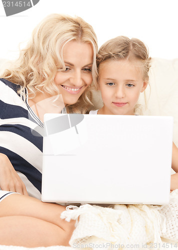 Image of happy mother and child with laptop computer