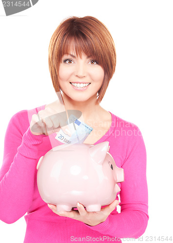 Image of lovely woman with piggy bank and money