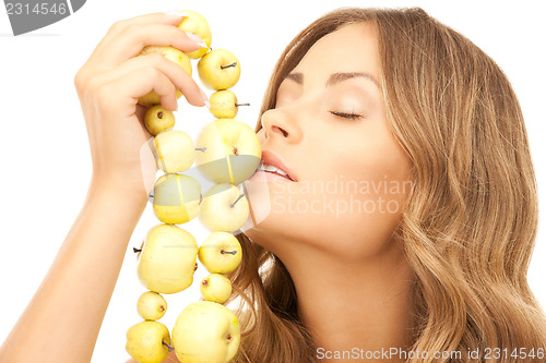 Image of lovely woman with green apples