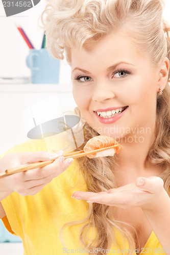 Image of lovely woman eating sushi