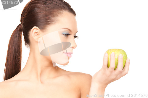 Image of young beautiful woman with green apple