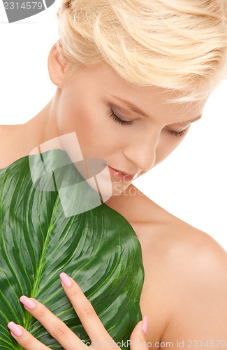 Image of woman with green leaf