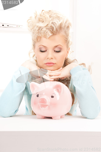 Image of lovely woman with piggy bank