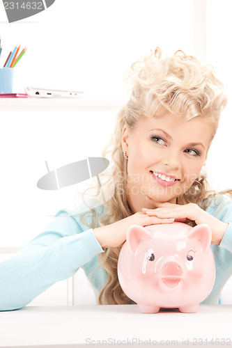 Image of lovely woman with piggy bank