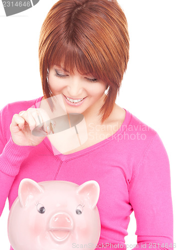 Image of lovely woman with piggy bank and money