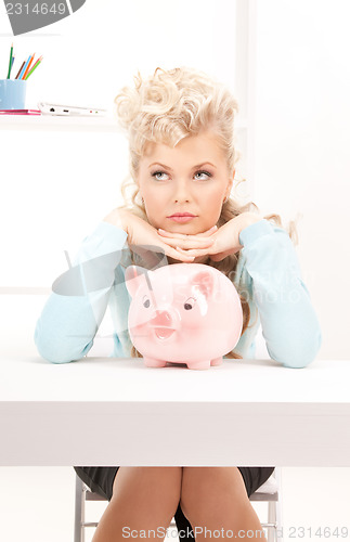 Image of lovely woman with piggy bank