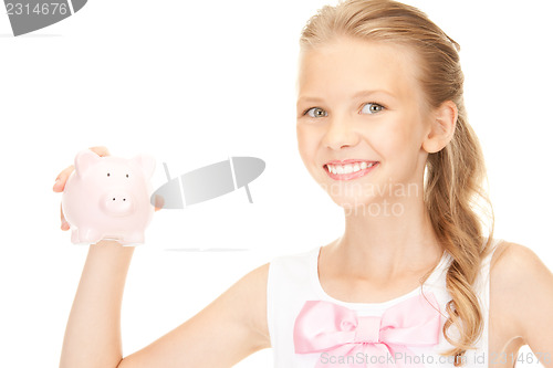 Image of lovely teenage girl with piggy bank
