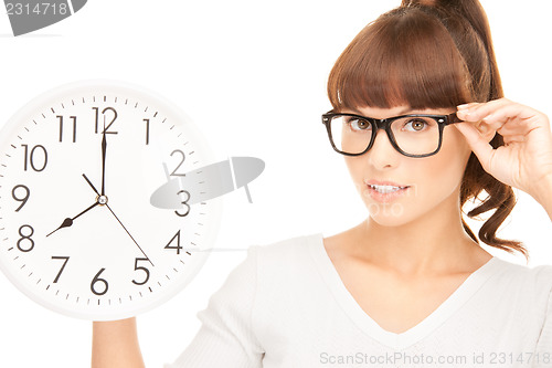 Image of woman holding big clock