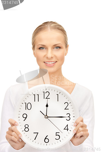 Image of woman holding big clock