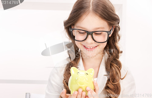 Image of little girl with piggy bank