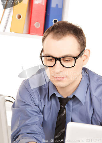 Image of businessman with laptop computer in office