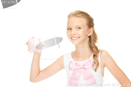 Image of lovely teenage girl with piggy bank