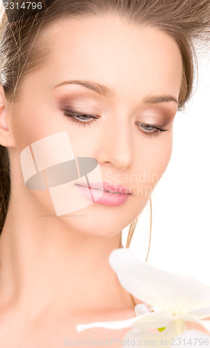 Image of beautiful woman with white flower