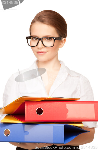Image of young attractive businesswoman with folders 