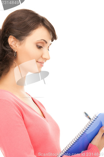 Image of young attractive businesswoman with notebook