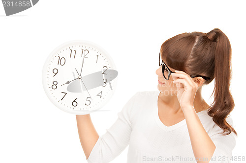 Image of woman holding big clock