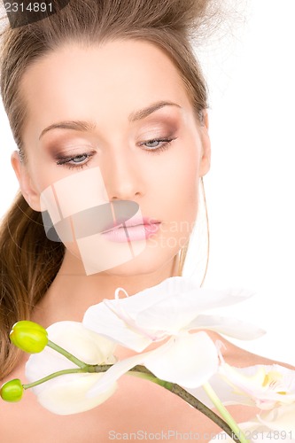 Image of beautiful woman with white flower