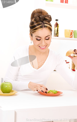 Image of woman with green apple and sandwich