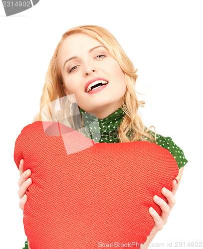 Image of woman with red heart-shaped pillow