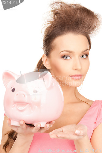 Image of lovely woman with piggy bank